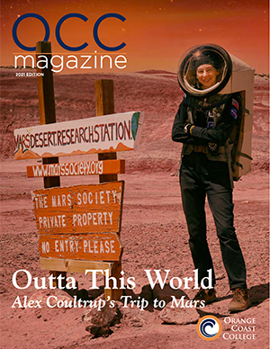 OCC Magazine 2021 front cover, Alex Coultrup in spacesuit on Mars Desert Research Station