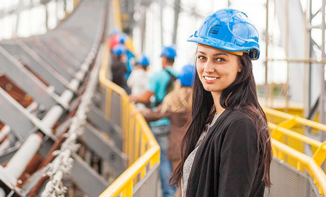 woman wearing a hard hat at a construction site