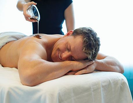 Male guest receives massage in spa