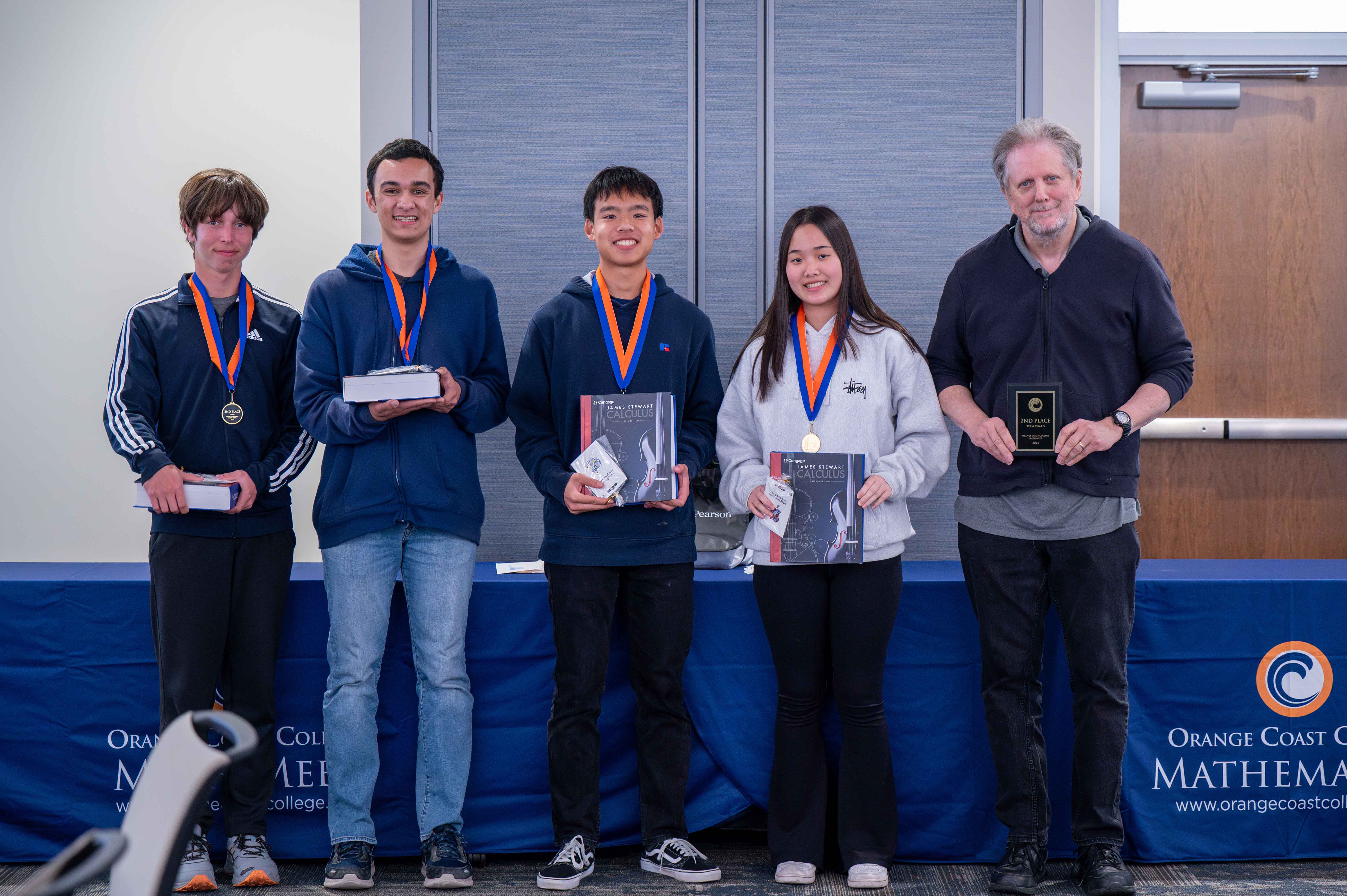 Los Alamitos High School students receive their plaque and medals for second place at the OCC Math Meet