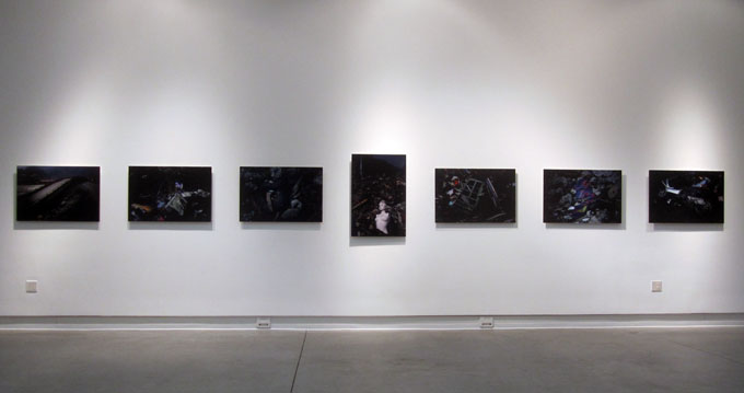 A straight view of photos on a white wall of the gallery