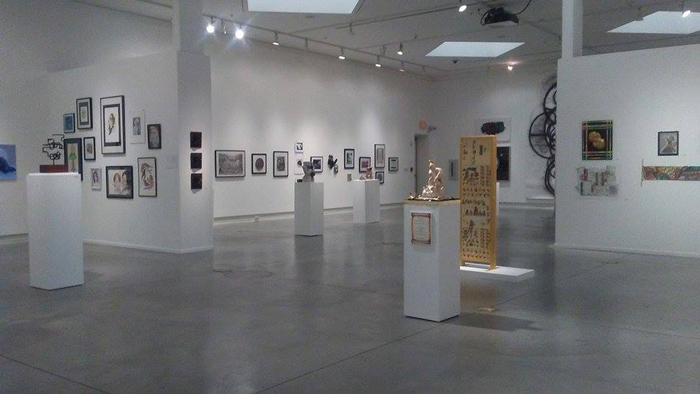 Wide view of the gallery with artworks in display