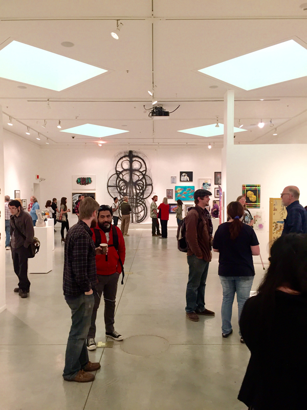 Many visitors walking in the gallery