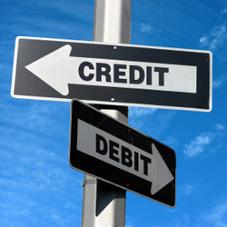 2 street signs with arrow point left labeled Credit and another pointing right labeled Debit.