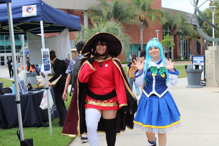two students walking in costume at student event