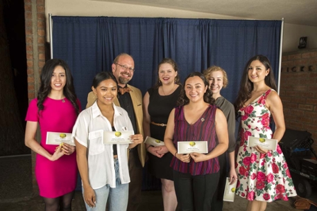 Scholarship winners posing with Director and their checks